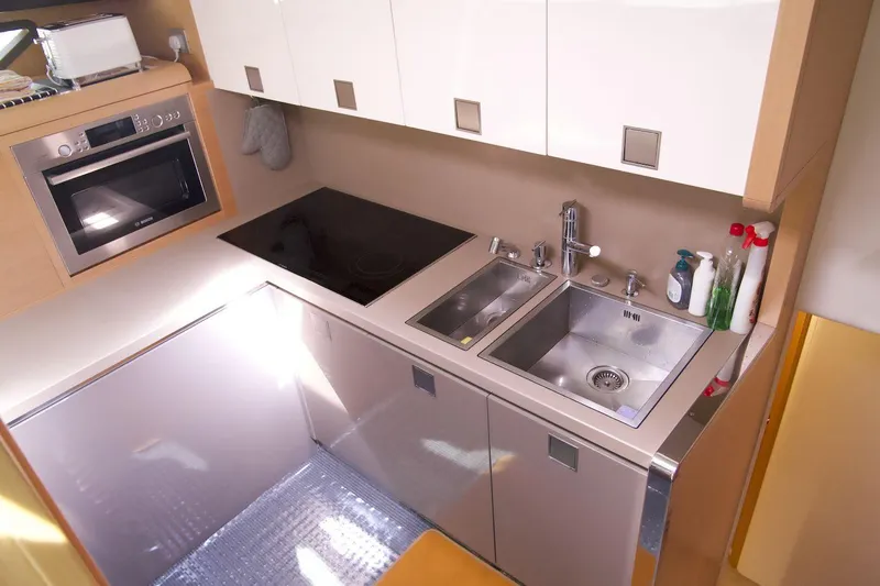 Antonina Yacht Photos Pics Modern kitchen in 2010 Ferretti Yachts 800 with sink, stove, and microwave.