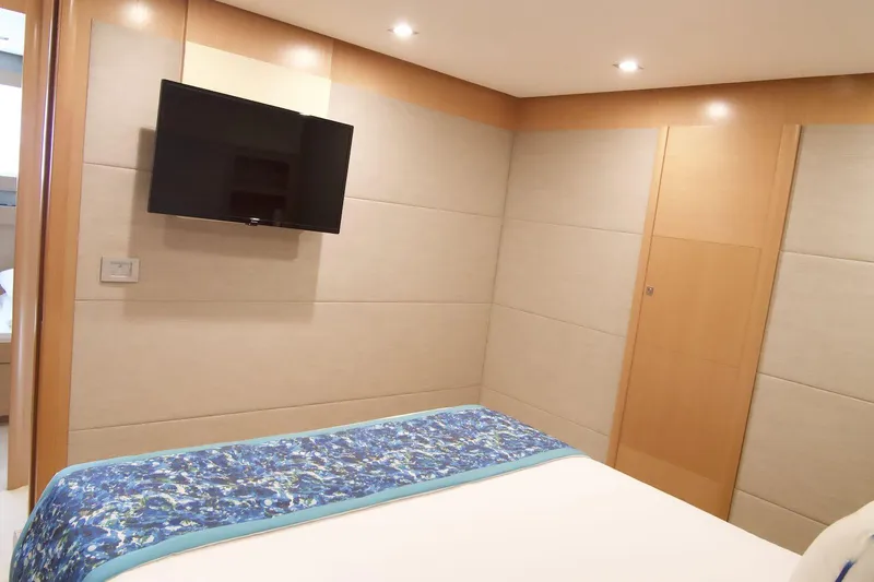 Antonina Yacht Photos Pics Luxurious bedroom interior of 2010 Ferretti Yachts 800 with modern decor and wall-mounted TV.