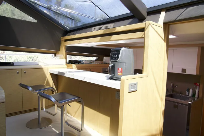 Antonina Yacht Photos Pics Luxurious interior of 2010 Ferretti Yachts 800 with modern kitchen and bar stools.