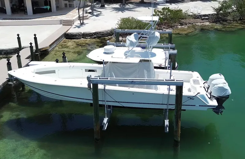 Warbird Yacht Photos Pics 2014 SeaVee 390B Center Console boat docked in clear water.