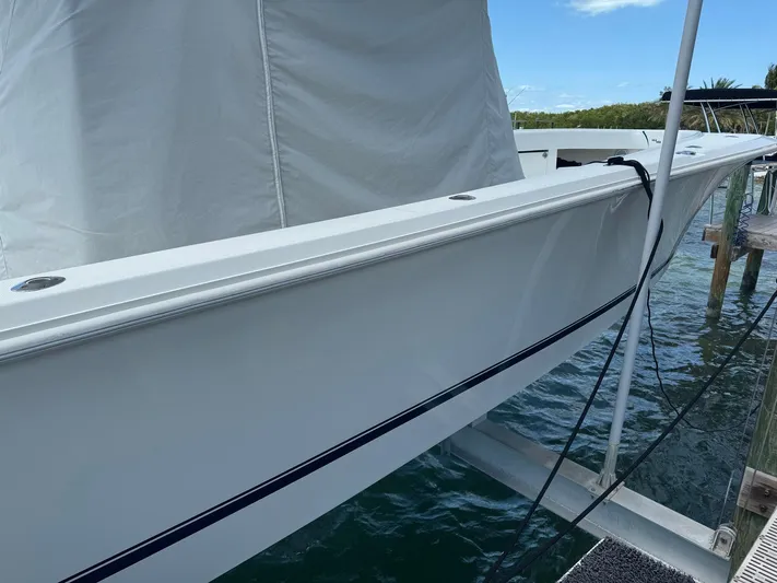 Warbird Yacht Photos Pics 2014 SeaVee 390B Center Console boat docked, side view with white hull and calm water.