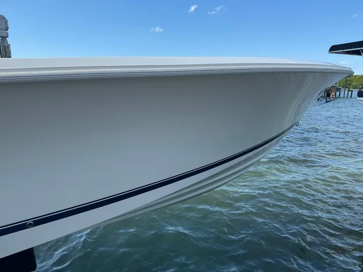 Warbird Yacht Photos Pics 2014 SeaVee 390B Center Console boat on water, side view.