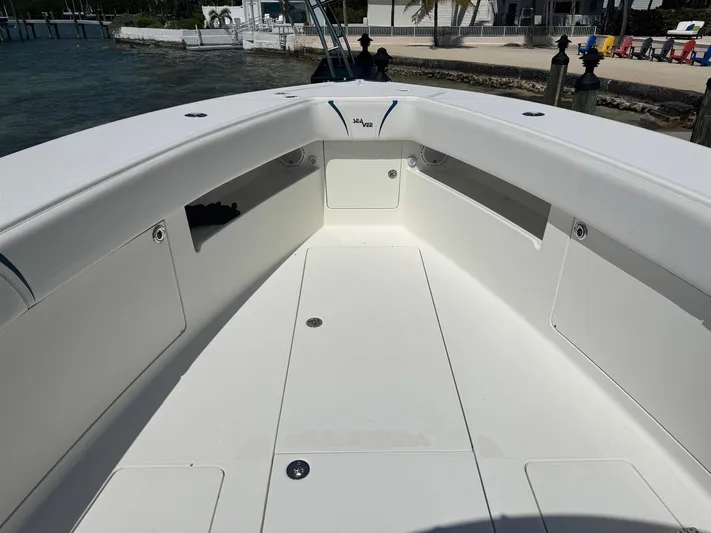 Warbird Yacht Photos Pics 2014 SeaVee 390B Center Console boat interior, featuring spacious deck and storage compartments.