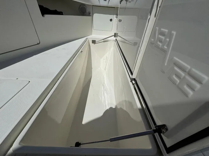 Warbird Yacht Photos Pics 2014 SeaVee 390B Center Console storage compartment, open and spacious interior view.