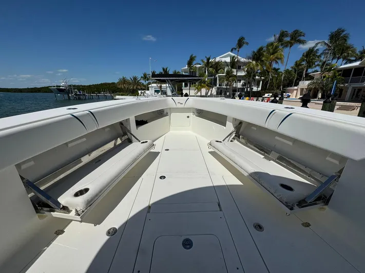 Warbird Yacht Photos Pics 2014 SeaVee 390B Center Console boat with spacious seating, docked near waterfront homes.
