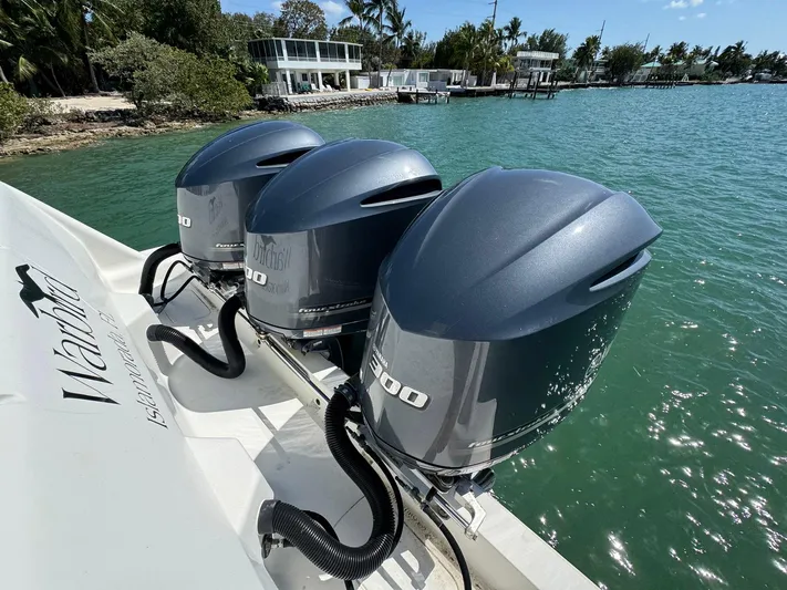 Warbird Yacht Photos Pics 2014 SeaVee 390B Center Console with triple outboard engines on turquoise water.