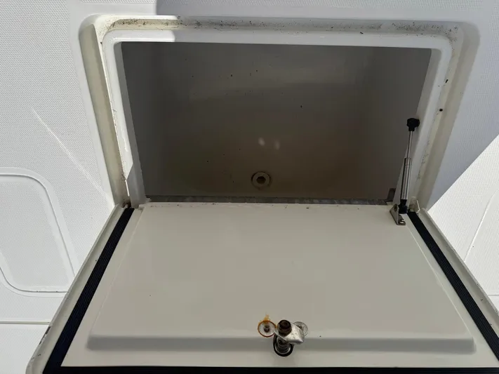Warbird Yacht Photos Pics 2014 SeaVee 390B Center Console storage compartment with open lid.