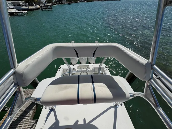 Warbird Yacht Photos Pics 2014 SeaVee 390B Center Console boat with white seating, overlooking calm blue water.