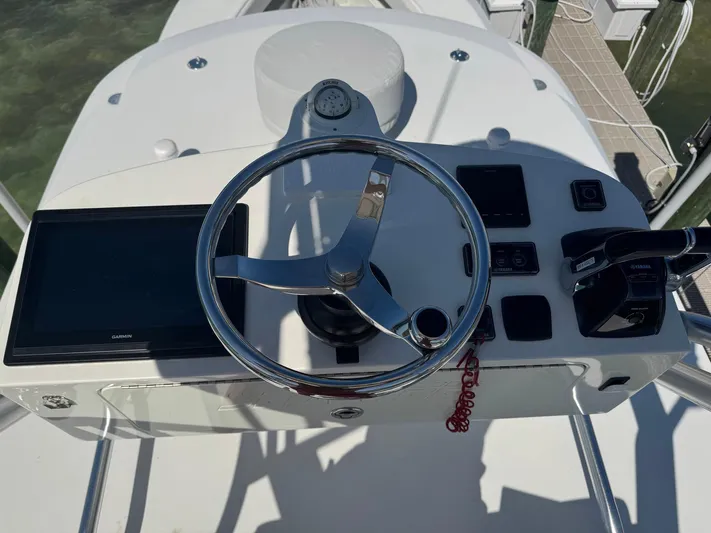 Warbird Yacht Photos Pics 2014 SeaVee 390B Center Console helm with steering wheel and navigation controls.