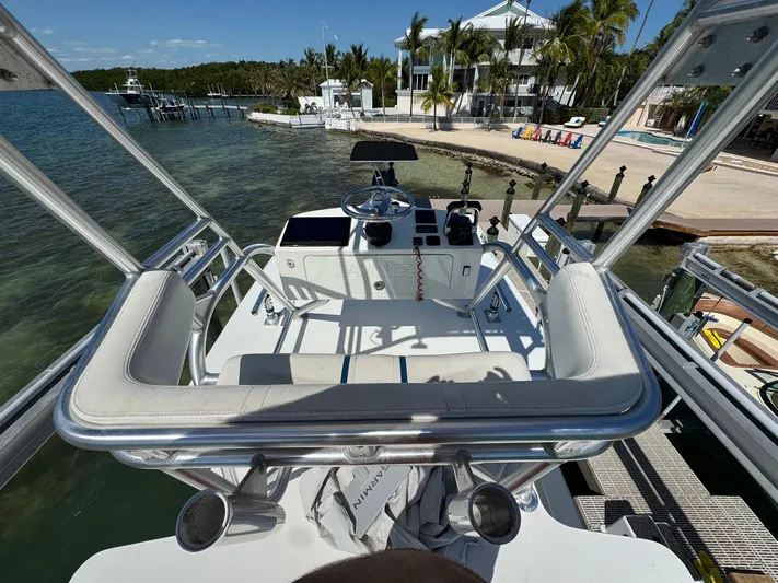 Warbird Yacht Photos Pics 2014 SeaVee 390B Center Console boat docked near a tropical waterfront home.