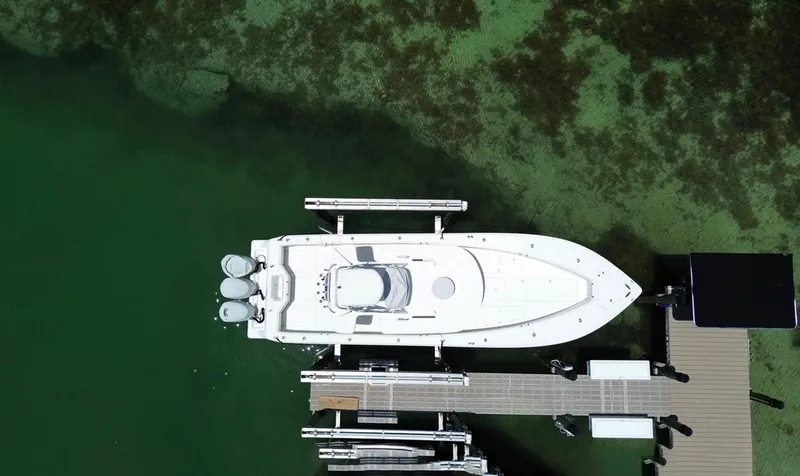 Warbird Yacht Photos Pics Aerial view of 2014 SeaVee 390B Center Console docked in clear green water.