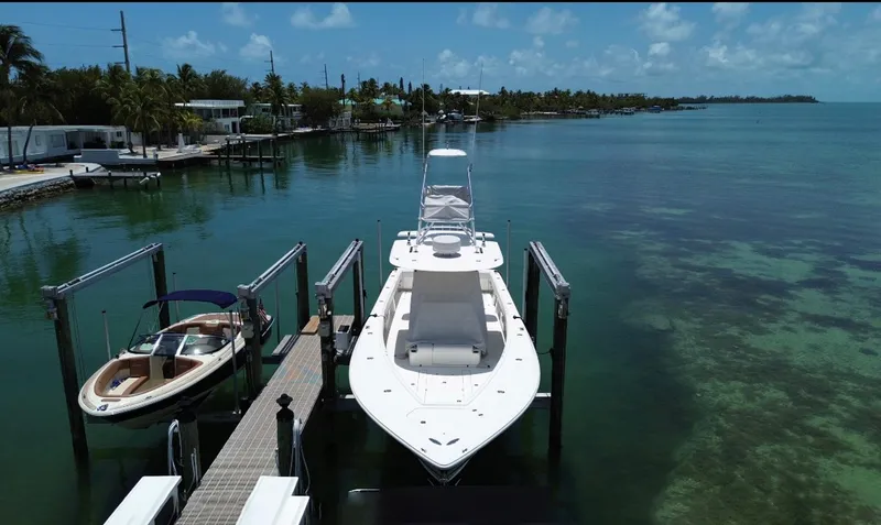 Warbird Yacht Photos Pics 2014 SeaVee 390B Center Console docked in a serene coastal setting.