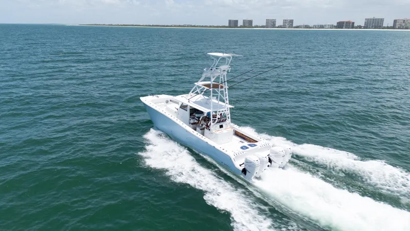  Yacht Photos Pics 2022 Freeman 43 boat cruising on open water with city skyline in background.