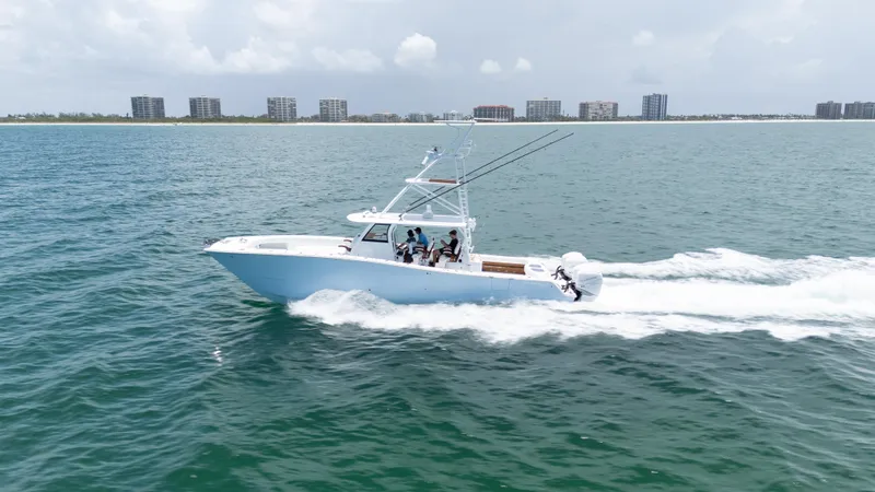  Yacht Photos Pics 2022 Freeman 43 boat cruising on ocean near city skyline.