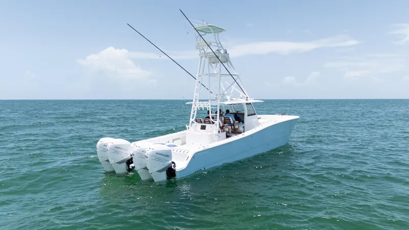  Yacht Photos Pics 2022 Freeman 43 boat on open sea with dual engines and tower under clear sky.