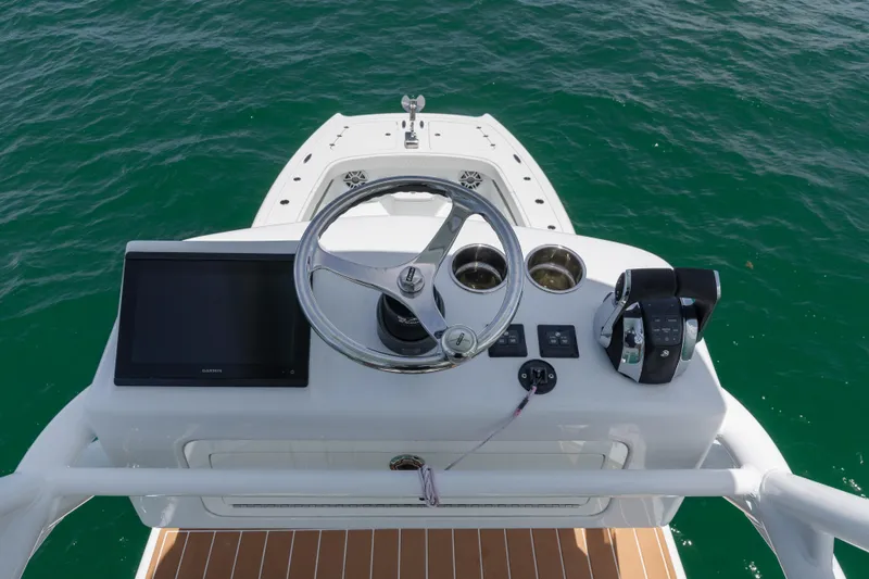  Yacht Photos Pics Freeman 43 boat helm with steering wheel and controls, 2022 model, on open water.