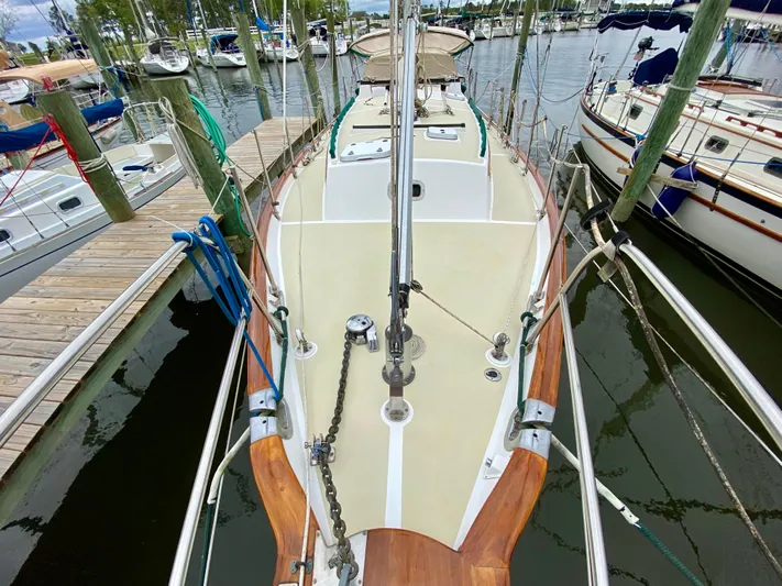 Private Idaho Yacht Photos Pics Cabo Rico 34 sailboat, 1993 model, docked at marina with wooden deck and rigging.