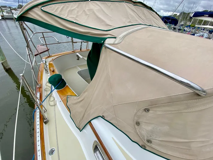 Private Idaho Yacht Photos Pics 1993 Cabo Rico 34 sailboat with beige canopy docked at marina.