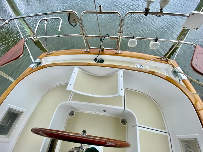 Private Idaho Yacht Photos Pics Cockpit of 1993 Cabo Rico 34 sailboat with wooden accents and steering wheel.