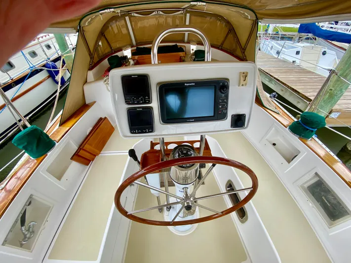 Private Idaho Yacht Photos Pics Cockpit of 1993 Cabo Rico 34 sailboat with steering wheel and navigation equipment.