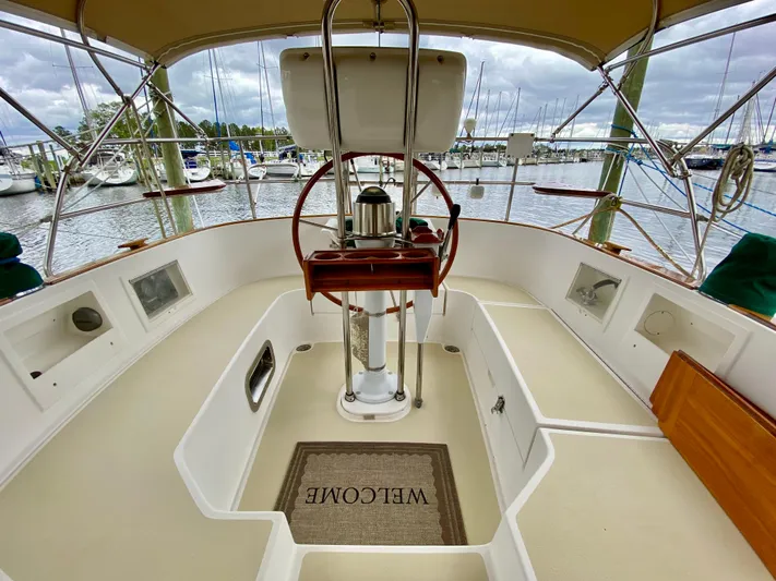 Private Idaho Yacht Photos Pics Cockpit of 1993 Cabo Rico 34 sailboat with welcome mat and marina view.