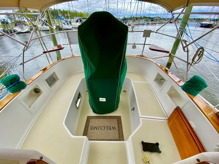 Private Idaho Yacht Photos Pics Cabo Rico 34 sailboat cockpit, 1993 model, with green cover and welcome mat, docked at marina.