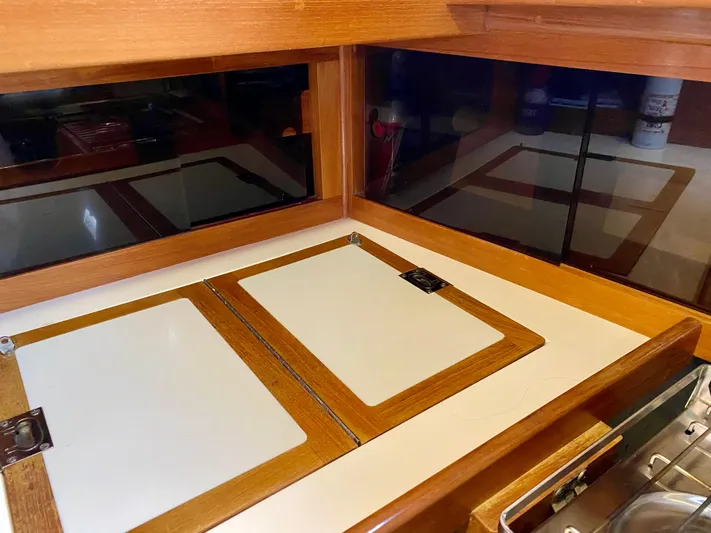 Private Idaho Yacht Photos Pics Interior of 1993 Cabo Rico 34 yacht with wooden cabinetry and storage compartments.