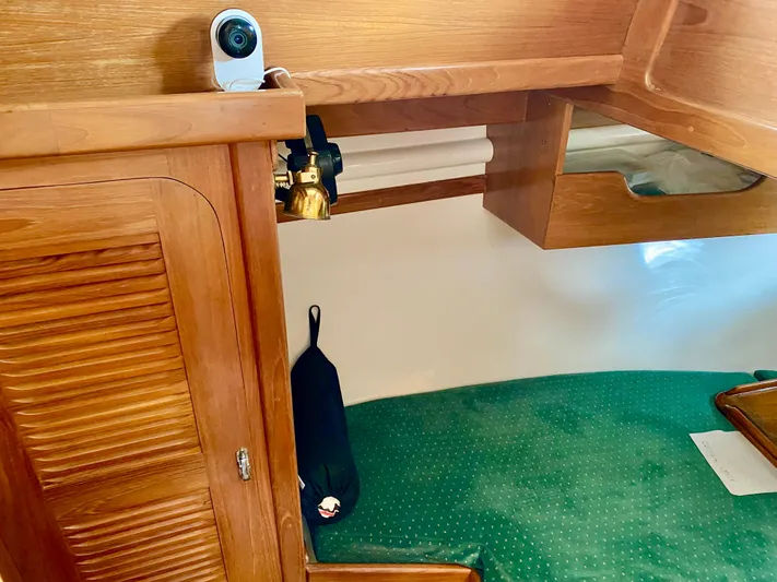 Private Idaho Yacht Photos Pics Interior of a 1993 Cabo Rico 34 sailboat with wooden cabinetry and green carpet.