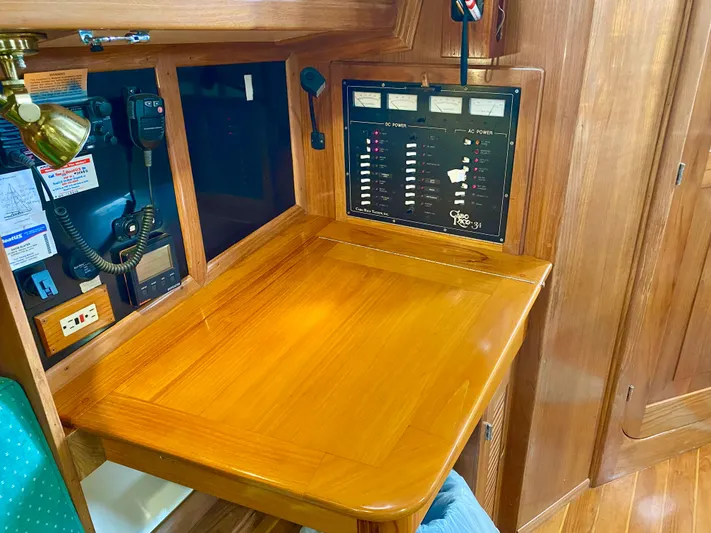 Private Idaho Yacht Photos Pics Navigation station on a 1993 Cabo Rico 34 sailboat with control panel and radio equipment.