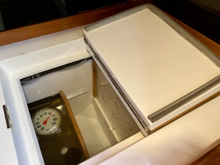 Private Idaho Yacht Photos Pics Open storage compartment with thermometer inside a 1993 Cabo Rico 34 yacht.
