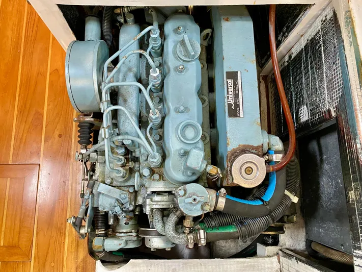 Private Idaho Yacht Photos Pics Engine of a 1993 Cabo Rico 34 sailboat, showcasing mechanical components and hoses.