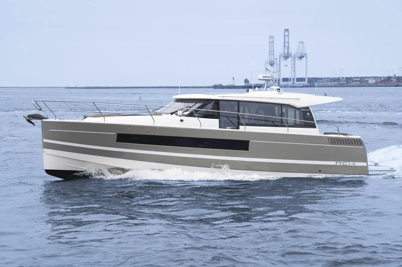 La Sirena Yacht Photos Pics 2014 Jeanneau NC 14 yacht cruising on open water near industrial port.