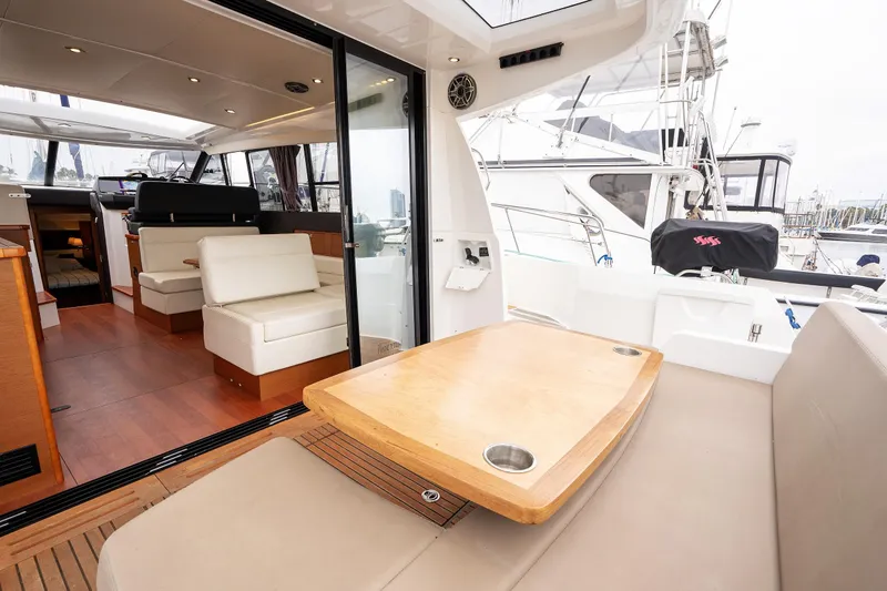 La Sirena Yacht Photos Pics Interior view of 2014 Jeanneau NC 14 yacht, featuring seating and dining area.