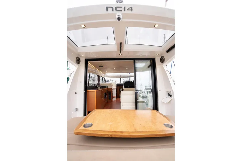 La Sirena Yacht Photos Pics 2014 Jeanneau NC 14 yacht interior with wooden table and modern design.