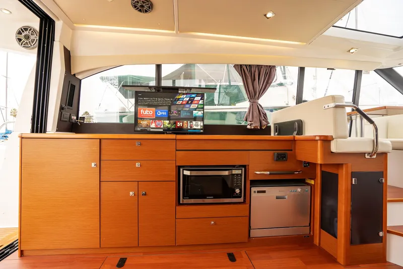 La Sirena Yacht Photos Pics Interior of 2014 Jeanneau NC 14 yacht with modern kitchen and entertainment system.