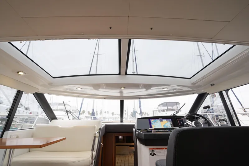 La Sirena Yacht Photos Pics Interior view of 2014 Jeanneau NC 14 yacht with panoramic windows and modern helm.
