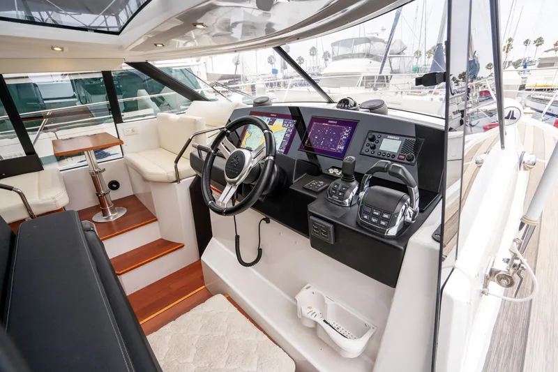La Sirena Yacht Photos Pics 2014 Jeanneau NC 14 yacht cockpit with modern navigation controls and luxurious seating.