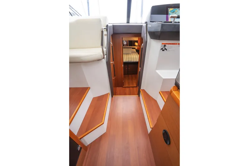 La Sirena Yacht Photos Pics Interior view of 2014 Jeanneau NC 14 yacht with wooden flooring and cabin access.