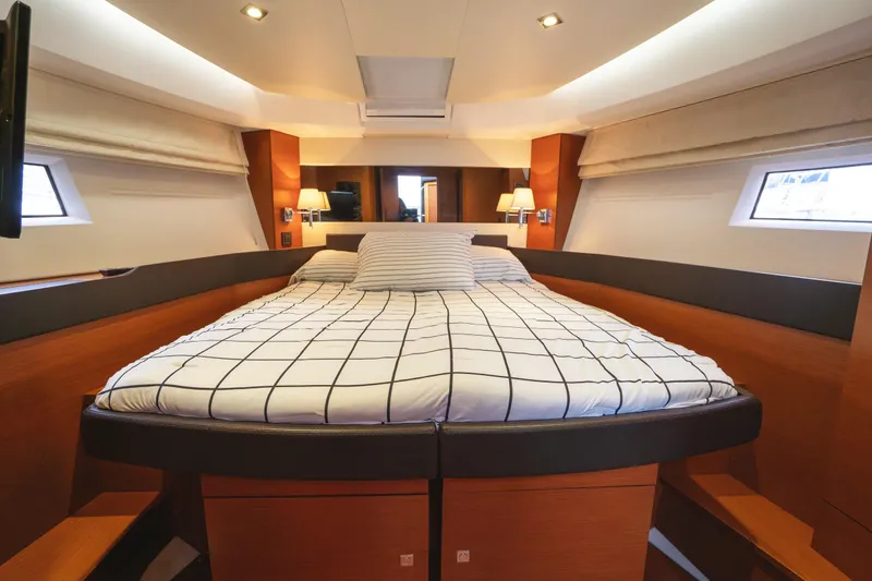 La Sirena Yacht Photos Pics Luxurious cabin interior of 2014 Jeanneau NC 14 yacht with cozy bed and modern design.