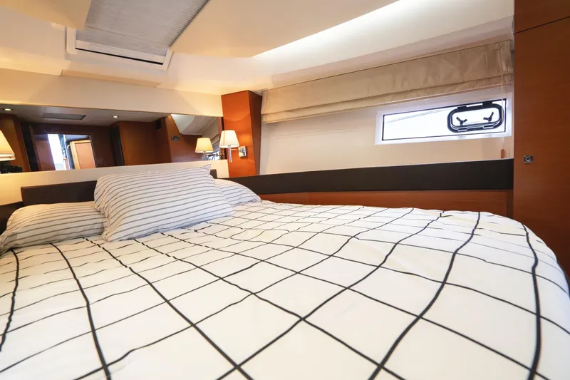 La Sirena Yacht Photos Pics Luxurious interior cabin of 2014 Jeanneau NC 14 yacht with modern bedding and lighting.