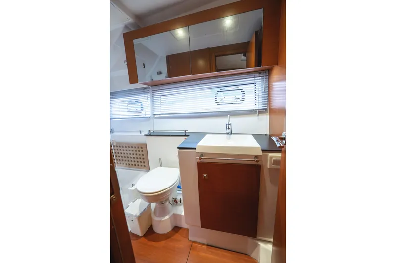 La Sirena Yacht Photos Pics Bathroom interior of 2014 Jeanneau NC 14 yacht with modern fixtures and wooden accents.
