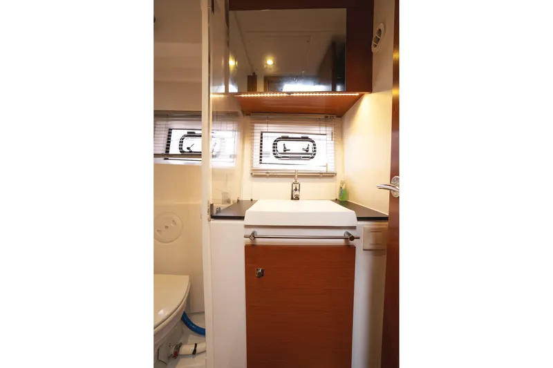 La Sirena Yacht Photos Pics 2014 Jeanneau NC 14 yacht bathroom with modern sink and window blinds.