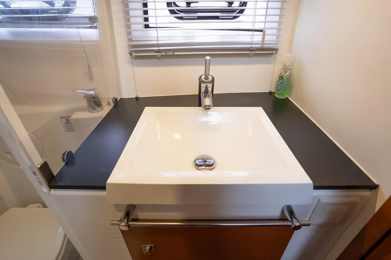 La Sirena Yacht Photos Pics Modern bathroom sink in 2014 Jeanneau NC 14 yacht, featuring sleek design and chrome fixtures.