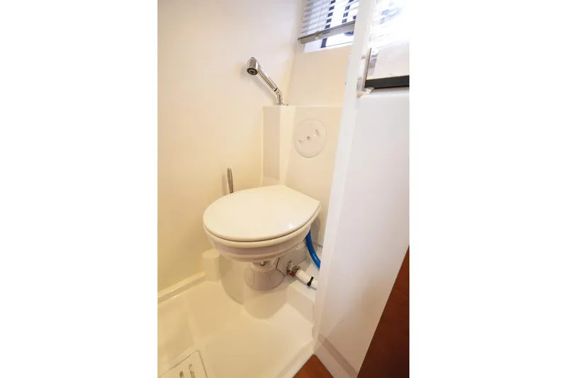 La Sirena Yacht Photos Pics 2014 Jeanneau NC 14 yacht bathroom with compact toilet and shower.