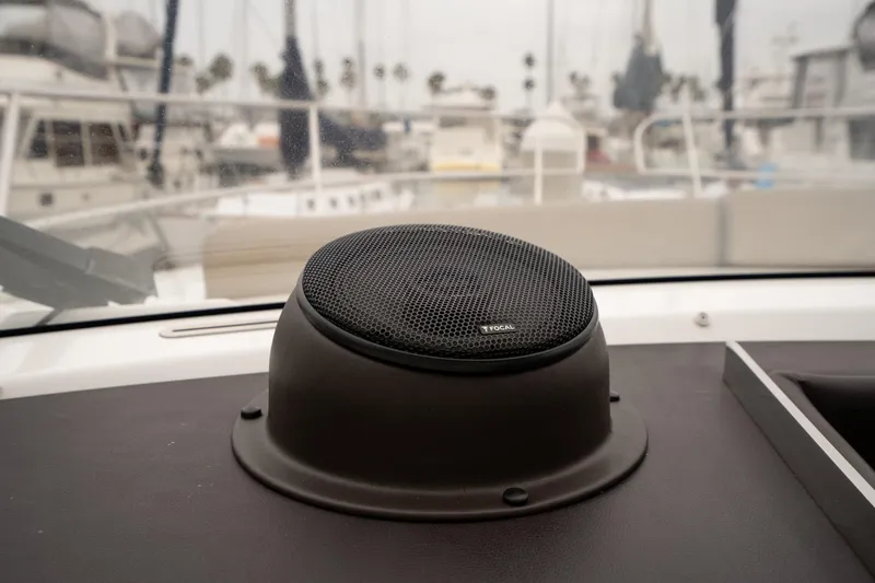 La Sirena Yacht Photos Pics Speaker on Jeanneau NC 14 yacht dashboard, 2014 model, with marina background.