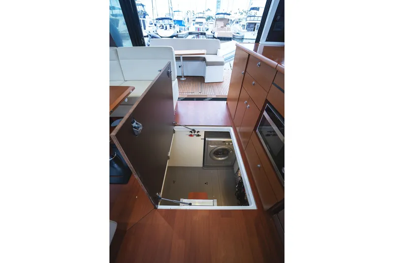La Sirena Yacht Photos Pics Interior of 2014 Jeanneau NC 14 yacht with open floor hatch revealing storage area.