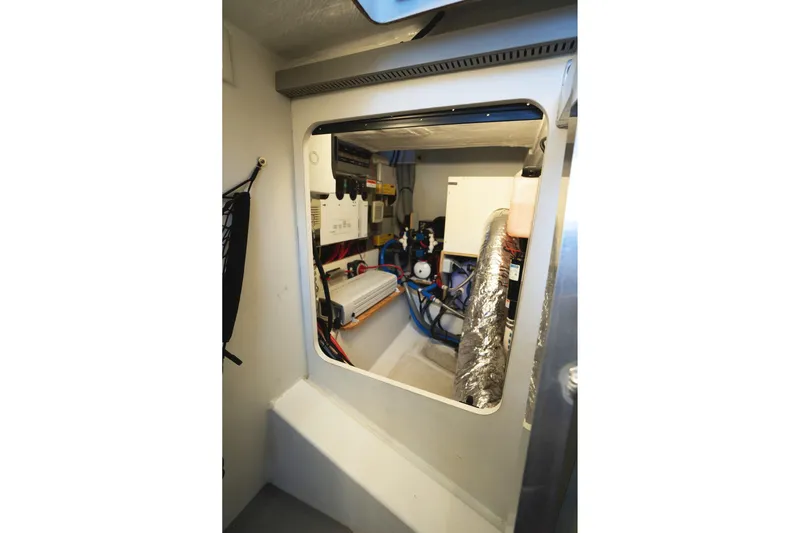 La Sirena Yacht Photos Pics Engine room of 2014 Jeanneau NC 14 boat, showcasing mechanical components and wiring.