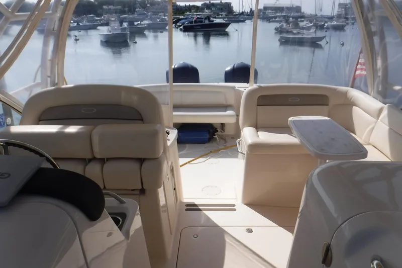  Yacht Photos Pics 2016 Grady White 355 Freedom boat interior with seating and table, docked in marina.
