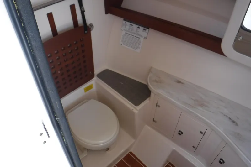  Yacht Photos Pics 2016 Grady White 355 Freedom boat bathroom interior with toilet and storage cabinets.