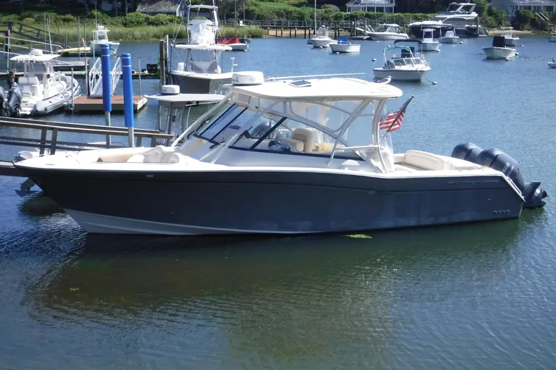  Yacht Photos Pics 2016 Grady-White Freedom 335 boat docked in a marina, featuring dual engines.